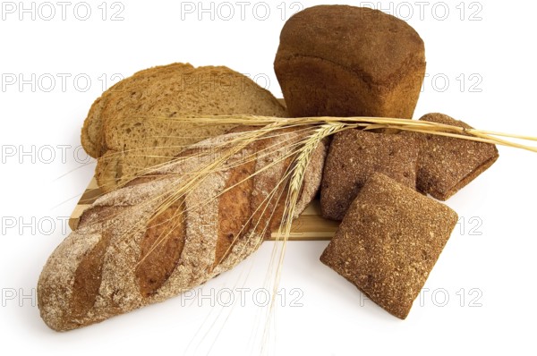 Various rye bread with a wooden board with stems of rye isolated on a white background, Russia,