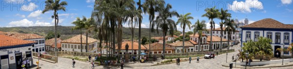 Panorama of traditional houses and palm tree lined street in historic center of Diamantina on a
