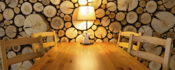 Christmas banner, living room interior table in wooden house, room decoration, lamp and angel