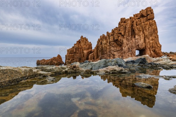 Rocce Rosse, the red rocks of Arbatax are reflected in a tidal pool, Arbatax, Tortoli, Ogliastra,