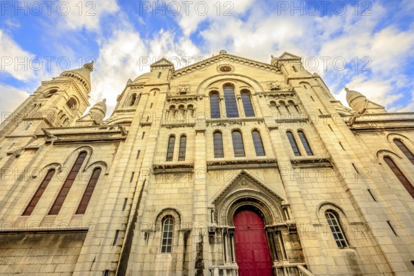 Left side facade and door of Basilique Sacred Heart in Montmartre of Paris in France with no people