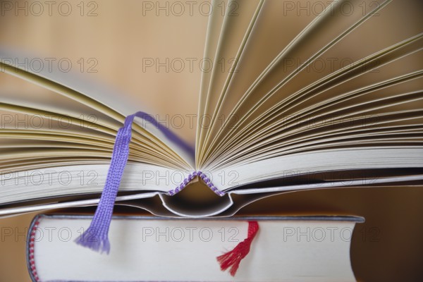 Fabric ribbon as bookmark - open book with bookmark ribbon, close-up
