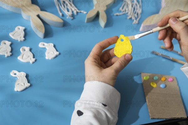 Master class of coloring Creator is using white air dry clay for making decor to EASTER holiday.