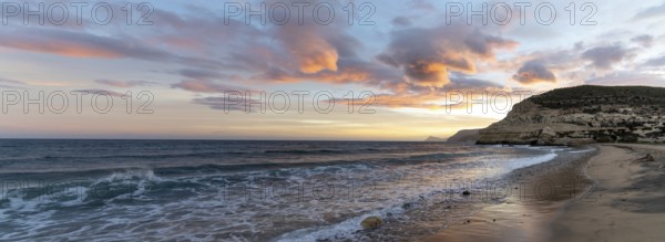 A beautiful panorama ocean sunset on the Costa del Sol in Spain with beach and cliffs in the
