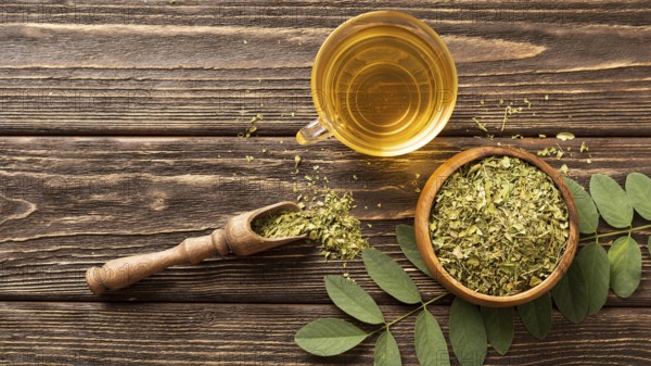 Flat lay green leaves cup tea