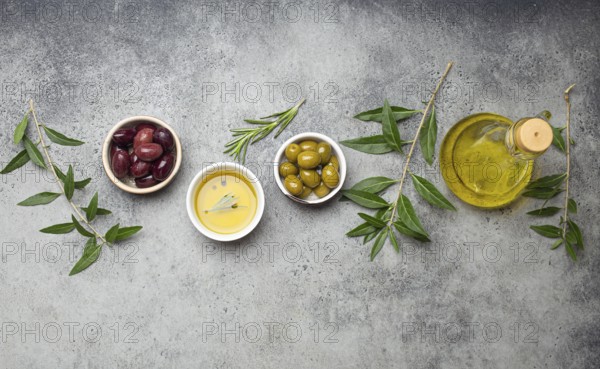 Composition with green and brown olives, extra virgin olive oil in glass bottle, olive tree