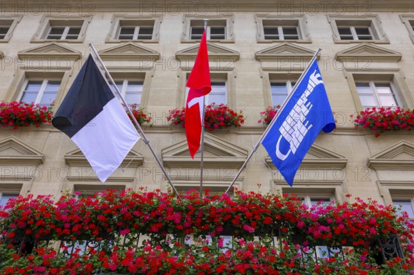 City Hall with Flag and Flowers in a Sunny Summer Day in City of Fribourg, Canton Fribourg,