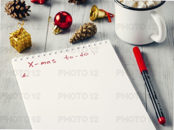 Christmas gifts shopping planning. Make shopping or to-do list for Christmas. Notebook, mug hot
