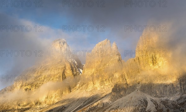 Foggy mountain landscape during sunrise of the picturesque Dolomiti at Passo Sella area in South