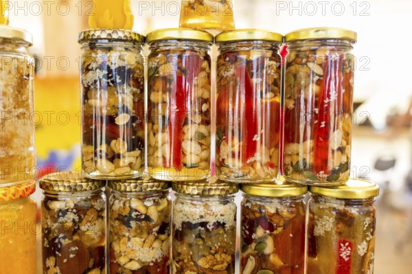 Honey with dried fruits and dried nuts - walnuts, hazelnuts, peanuts, almonds, cashews, plums,