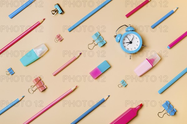 Creative student desk modern school supplies on neutral pastel beige background. Top view flat lay.