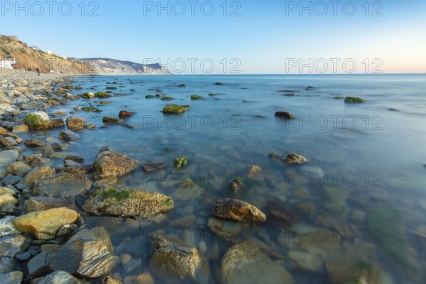 Stony sea beach of the 40th anniversary of the victory of the high coast of Anapa at sunset, Black