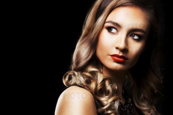 Beautiful woman with dark makeup and red lipstick posing on black background, Toronto, Canada,
