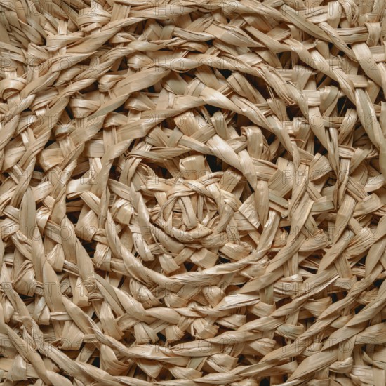 Circular pattern of woven seagrass basket. Abstract background - natural rattan or sea grass in