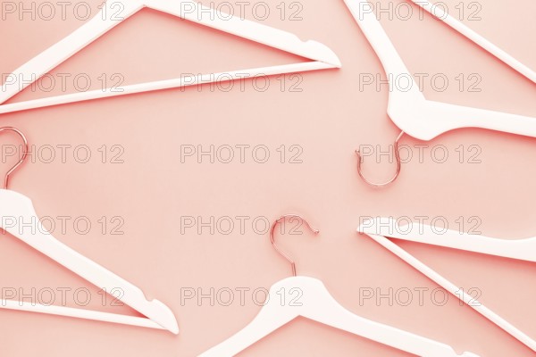 Creative top view flat lay wooden hangers toned living coral color of the year 2019 background copy
