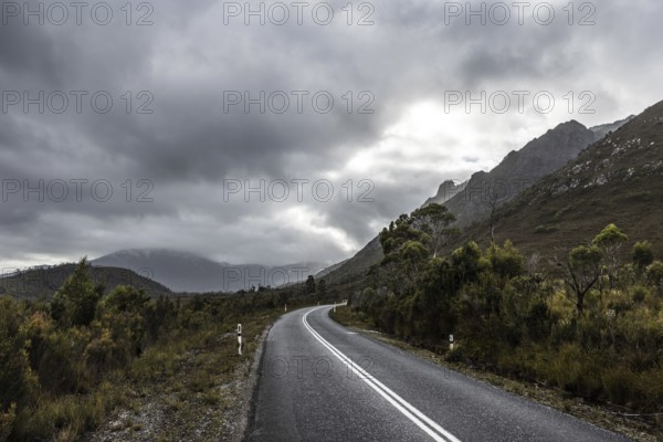 The picturesque Gordon River Rd at the Sentinel range of mountains near Bitumen Bones Sculpture on
