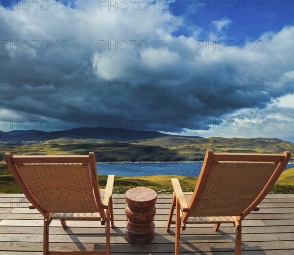 Two comfortable wooden sun loungers on the shore of the lake. Torres del Paine National Park.