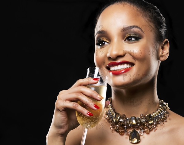 Romantic Indian woman with golden makeup and nailpolish. Big gold fashion necklace. Black isolated