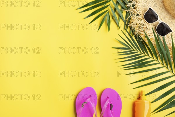 Vacation travel planning simple theme of straw hat sunglasses flip flops and palm leaves on uniform
