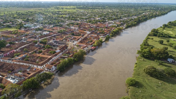 Aerial view of the historic town Santa Cruz de Mompox in sunlight with river and green