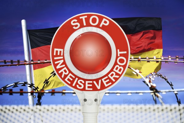 Police trowel with the inscription Stop Entry Ban in front of the German flag and barbed wire,