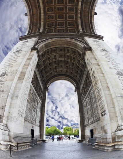 The striking and unexpected angle Arc de Triomphe in Paris. Background - the cloudy sky. Photo was