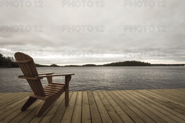 Known as Muskoka or Adirondack chairs sit on a dock at a resort in Muskoka, Ontario, Canada, North