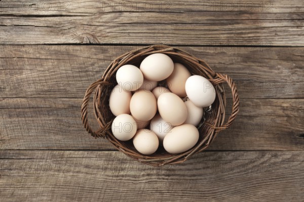 Organic chicken eggs in basket on wooden background. Organic household concept with eggs from