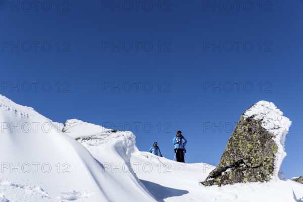 Sofia, Bulgaria - March 12, 2016: Two free riders are prepairing for skiing down a snowy rocky
