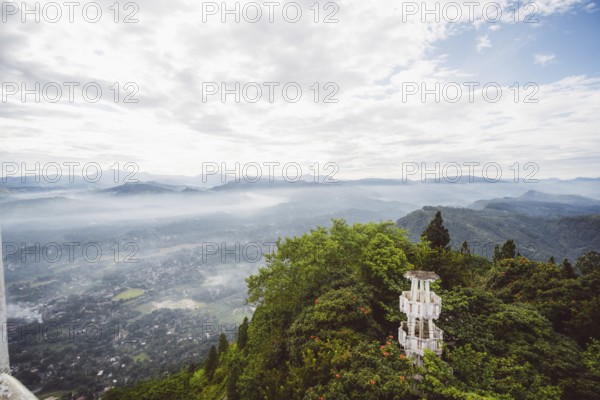 Panoramic view of a hilly, wooded landscape with a tower in the foreground, Anamanawa Tower, Sri