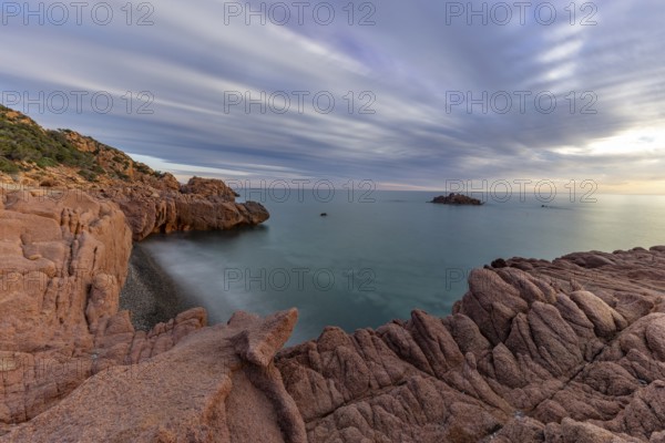 Coast with bizarre red rocks and sea view at sunset, long exposure, Spiaggia di Cala E'Luas,