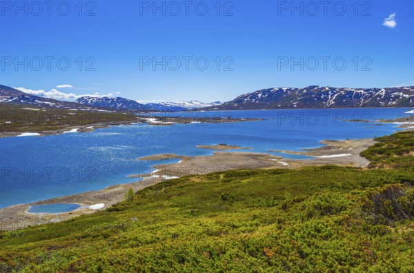 Amazing Vavatn lake panorama rough landscape view rocks boulders and mountains during summer in
