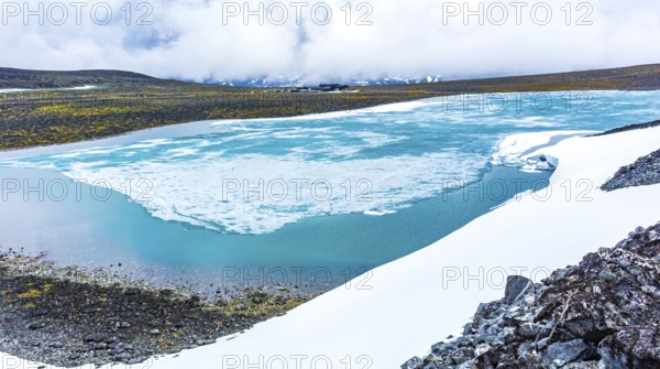 Galdhøpiggen snow-covered in summer in Jotunheimen Lom in Norway is the largest and highest