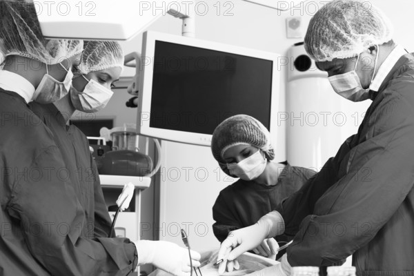 Surgery team operating in a surgical room