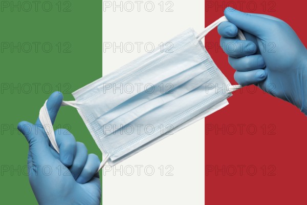 Medic holding respiratory face mask in hands in blue gloves on background flag of Italy or Italian