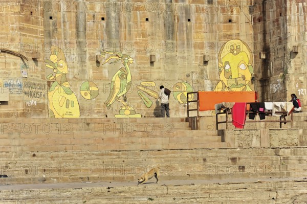 Varanasi, Uttar Pradesh, India, Asia, Wall paintings next to the steps of a Ganges Ghat with