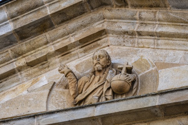 Detail of the pediment of the entrance portico of Zamora Cathedral with sculpture of Christ holding