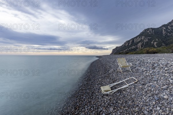 Lonely, deserted, deserted beach with two abandoned deckchairs, long exposure, Coccorocci,