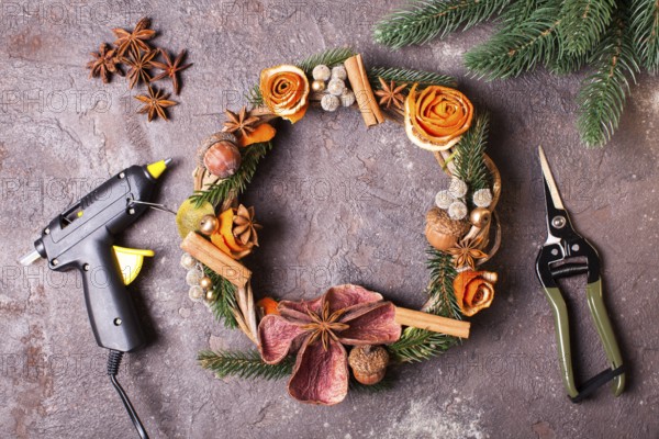 Christmas aromatic eco wreath with dry orange and anise stars, decorated tangerine peel roses,