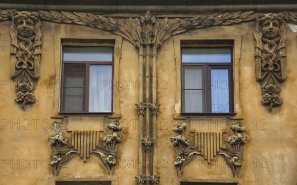 Fragment of the facade with a balcony of an Art Nouveau-style residential building in the city
