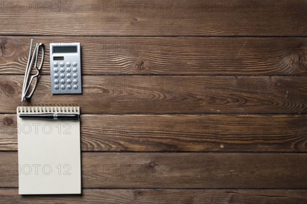 Still life of accountant workspace with office accessories. Flat lay wooden desk with elegant
