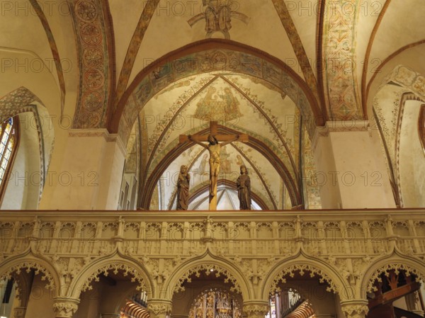 Church interior with an ornate altar and Christian figures under ornate frescoes and arches, holm,