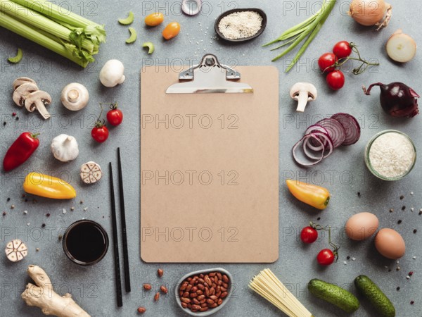 Asian ingredients and empty clipboard. Various of Chinese cooking ingredients and chopsticks on
