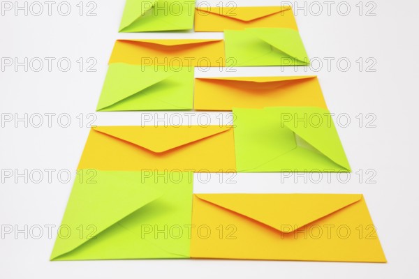Composition with yellow and green envelopes on the white table