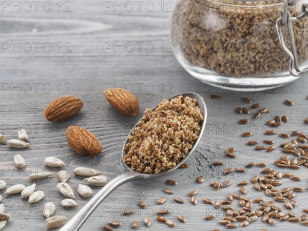 Homemade LSA mix in spoon - Linseed or flax seeds, Sunflower seeds and Almonds. Traditional
