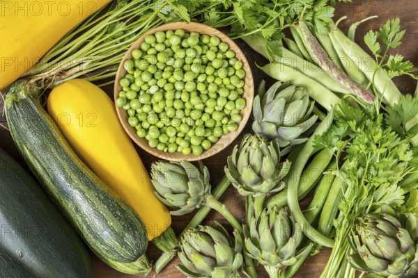 Fresh organic green vegetables wooden floor with copy space. Green and yellow vegetables background