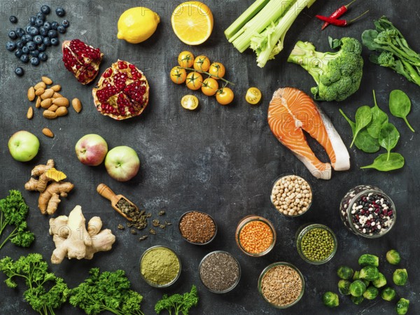 Clean Eating concept with copy space in center. Selection food ingredients for Clean Eating on dark