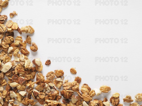 Homemade granola isolated one edge on white background. Ingredient for healthy breakfast. Copy