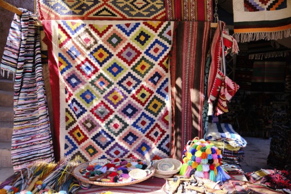 Traditional colorful berber hand woven wool carpets and rugs at middle eastern bazaar. Berber