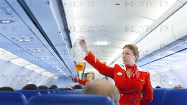 MOSCOW - MAY 28, 2011: Air hostess Yulia of Aeroflot shows how to use an oxygen mask on board.